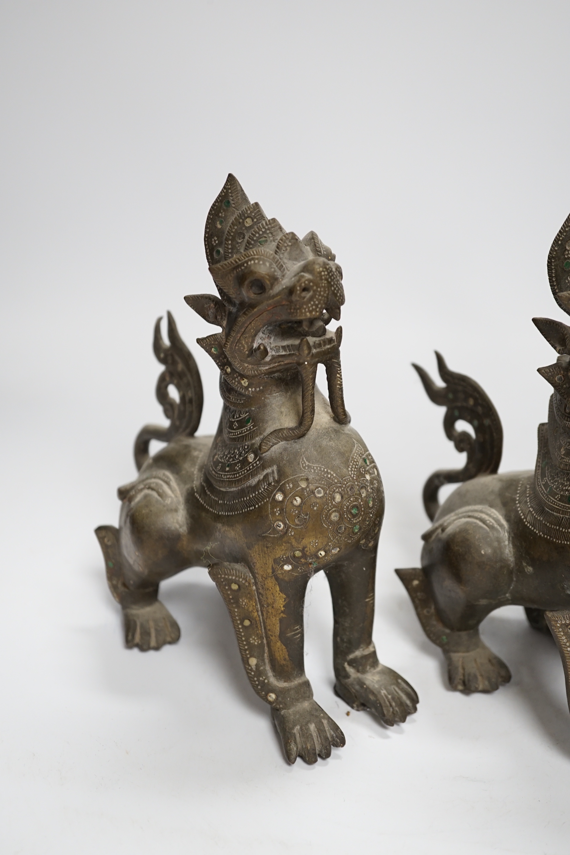 A pair of Thai bronze figures of lion dogs, 20cm